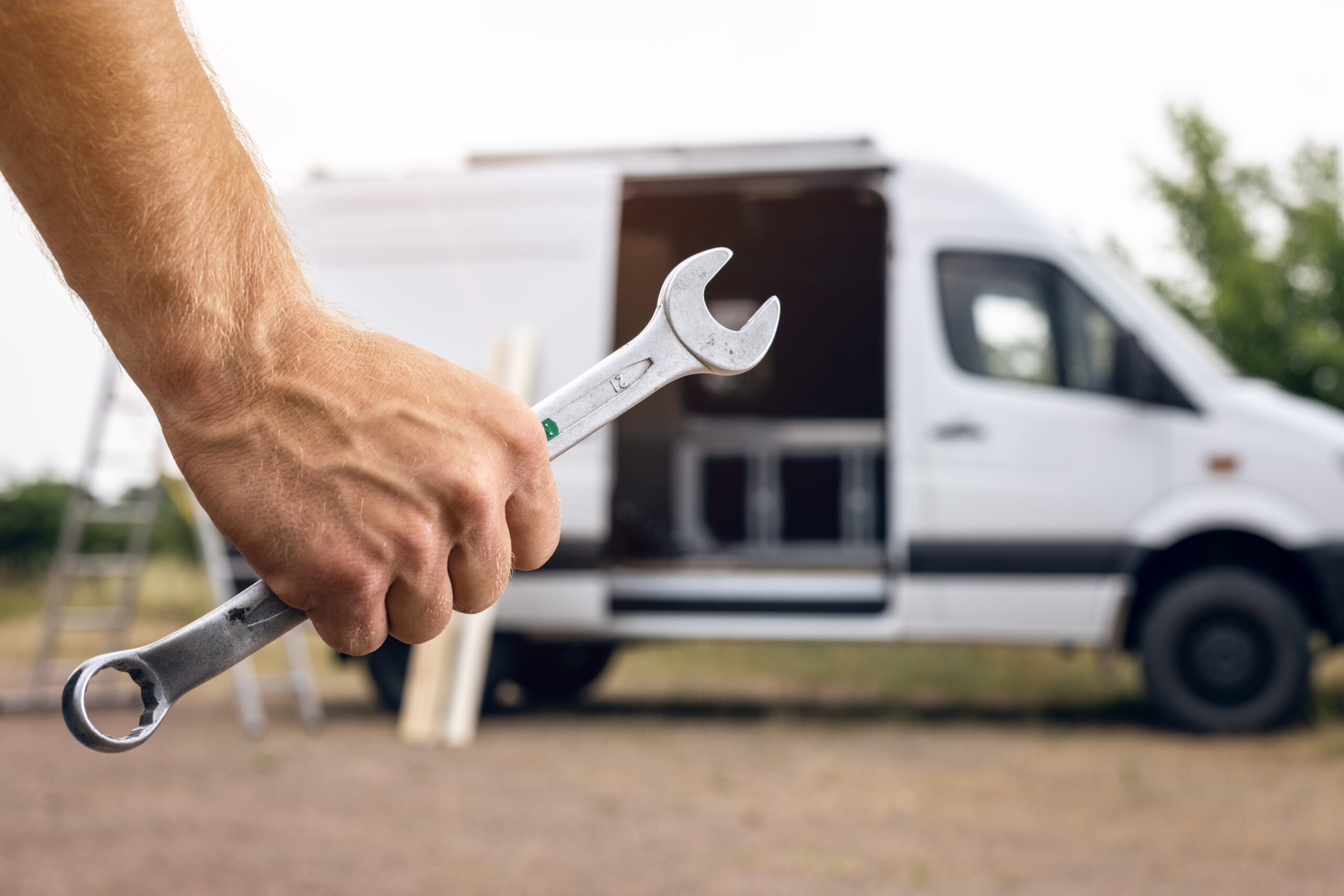Arm with wrench in front of sprinter van rv