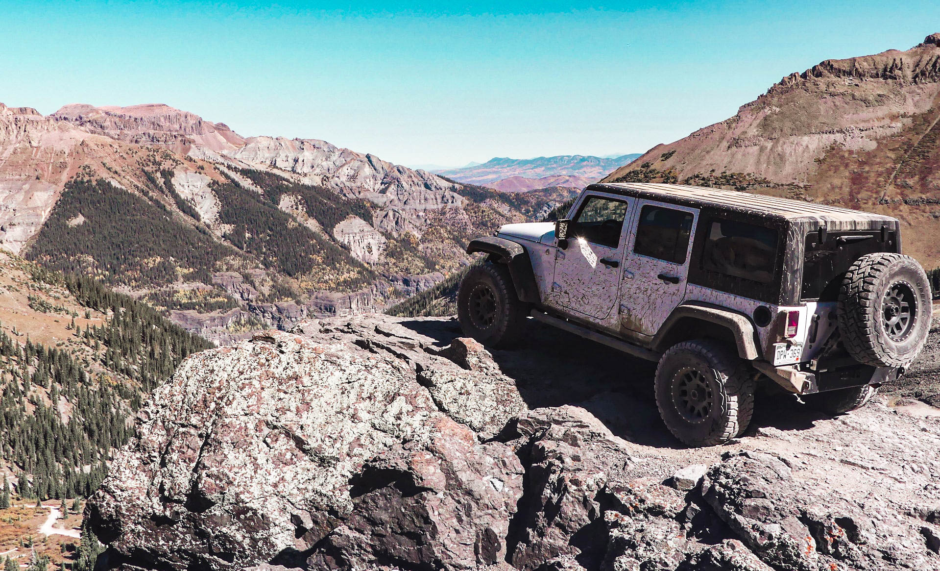 Jeep on mountain overlooking valley